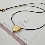 Black cord, stainless steel heart.