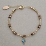 ...Natural stone bracelet with a turquoise-colored zirconia cross