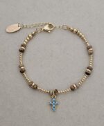 ...Natural stone bracelet with a turquoise-colored zirconia cross