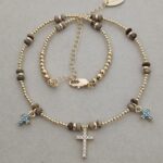 ...Natural stone necklace with turquoise-colored zirconia crosses